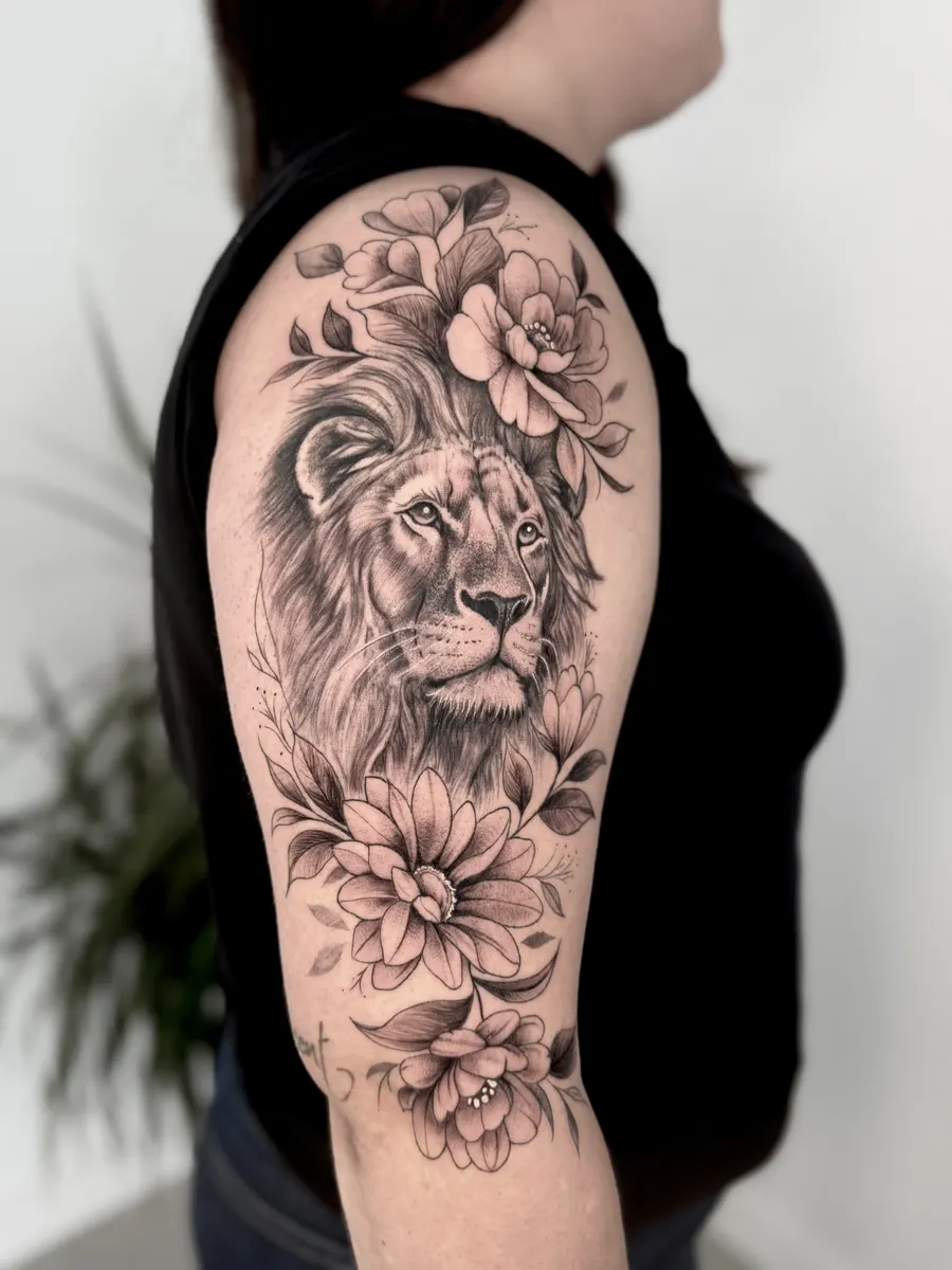 Lion's head in realism surrounded by fine line flowers, tattooed as a half sleeve